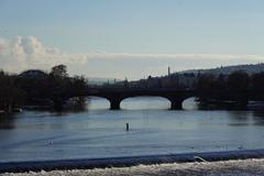 Charles Bridge in Prague during the day with tourists