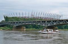 Warsaw water tram with Średnicowy Bridge and National Stadium in the background