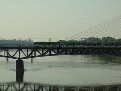 A train passing over the Wisła River as seen from the Poniatowski Bridge in Warsaw, Poland