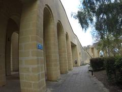 Unnamed Road in Attard, Malta with buildings and cars