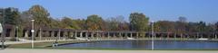 Scenic pergola in Wroclaw, Poland with lush greenery and a reflecting pool