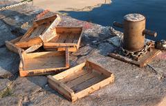 Abandoned fish boxes in Roses port, Spain