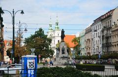 Panoramic view of Jan Matejko Square with a blue cabin toilet