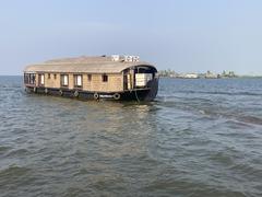 Scenic view of Alleppey backwaters with boats and palm trees