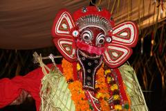 Guligan Theyyam performer in traditional attire and makeup