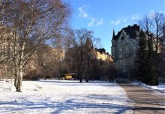 Tove Jansson's park in Helsinki with a yellow kiosk and Aeolus building in the background