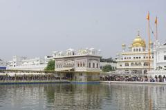 Golden Temple at night with lights reflecting on water