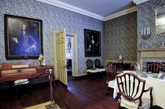 Parlor of the Bishop White House with vintage furniture and portraits on the wall