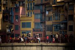 colorful houses along the Onyar River with Sant Agustí Bridge in Girona, Spain