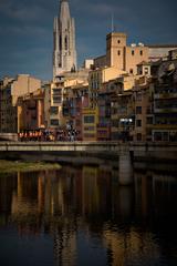 Colored houses of Onyar River in Girona with Sant Fèlix Church in the background