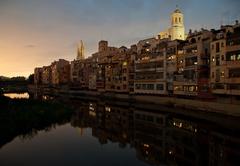 Night view of Cases de l'Onyar along the river in Girona