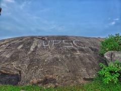 Small rock mountain at Tapovan with people walking around it