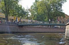 Bank Bridge in Saint Petersburg with griffin statues and people crossing