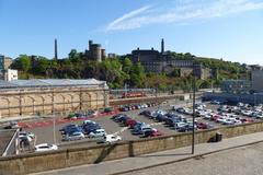 Calton Hill in Edinburgh with National Monument and Nelson Monument under a blue sky