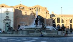 Piazza del Repubblica at sunset with people walking and historic buildings in the background