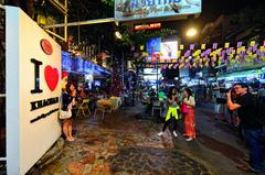 Khao San Road in Bangkok with shops and tourists on a bustling street