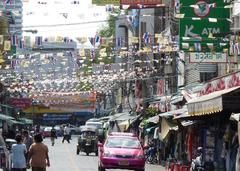 Street in Banlangphu subdistrict of Bangkok with a taxi and an auto rickshaw in the foreground