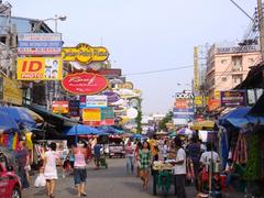 Khao San Road in Bangkok, Thailand, bustling with people and illuminated signs at night