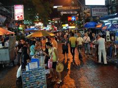 Khao San Road at night filled with vibrant lights and bustling crowds