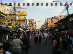 Khao San Road at night with colorful neon signs and street crowd