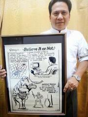 Ireneo Bughao holding Ripley's Believe It or Not! cartoon featuring his unique ability