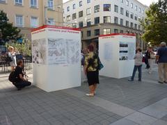 People viewing informational pillars in Brno's Moravské náměstí