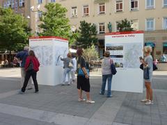 People viewing informational pillars about Brno main train station referendum