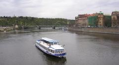 Cechuv Bridge in Prague with a boat on Vltava River