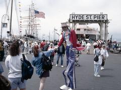 Uncle Sam stilt walker greets woman at Hyde Street Pier on Independence Day