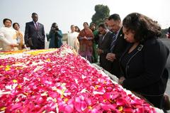 Reverend Jesse Jackson and family praying at Mahatma Gandhi's grave