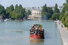 Barge in bassin de la Villette with Rotonde de la Villette in Paris