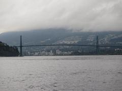 Lion's Gate Bridge in the daytime with traffic and surrounding greenery in Vancouver, Canada