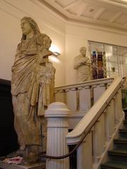 entrance of Allard Pierson Museum in Amsterdam with plaster-cast statue of Mausolus