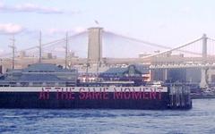 Lawrence Weiner's conceptual artwork 'At the Same Moment' on East River pilings