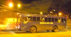 NYC night bus passes Manhattan Bridge