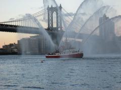 Manhattan Bridge and fireboat under Brooklyn Bridge during 125th Anniversary celebration