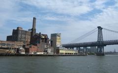 View of Domino plant and bridge from ferry on cloudy afternoon