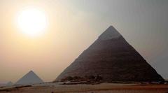 Giza pyramids of Khufu, Khafre, and Menkaure at sunset