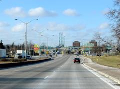 Huron Church Road leading to Ambassador Bridge with University of Windsor buildings