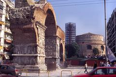 Southwest view of the Arch of Galerius with scaffolded minaret and Rotunda in the background