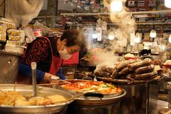 Gwangjang Market vendor serving food in Seoul, South Korea