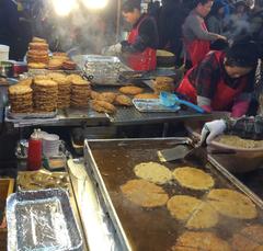 Market vendors frying bindaetteok at Gwangjang Market, Seoul