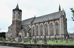 Dunblane Cathedral with old gravestones in the churchyard