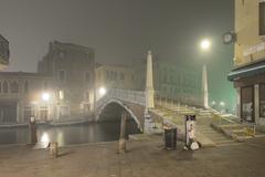 Ponte delle Guglie bridge in Venice at night with mist