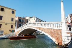 Scenic view of Venice canal with boats and historical buildings