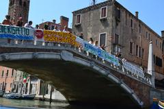 Venice Is My Future protest in Venice, Italy with a view of historical architecture