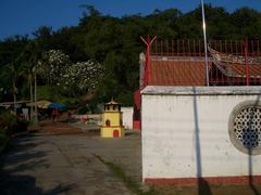 Hang Li Poh Well enclosure with Poh San Teng Temple in the background and Bukit Cina cemetery hill