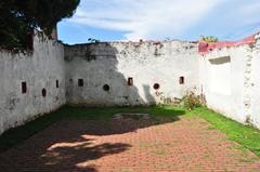 Malacca Sultanate Palace Museum with large garden and people walking