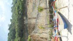 Tanjung Benoa Beach with boats and a sea wall