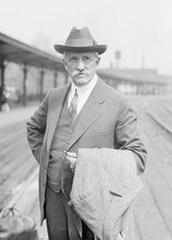 Portrait of Dr. James Breasted standing on a train platform